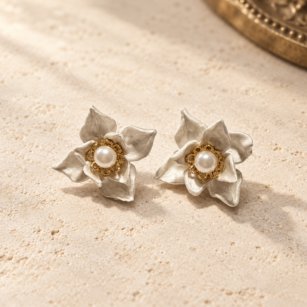 Handmade ivory porcelain clay magnolia stud earrings with freshwater pearl centers and gold-plated details