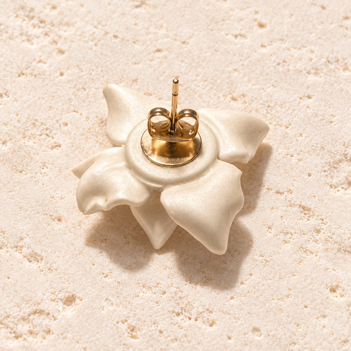 Handmade ivory porcelain clay magnolia stud earrings with freshwater pearl centers and gold-plated details