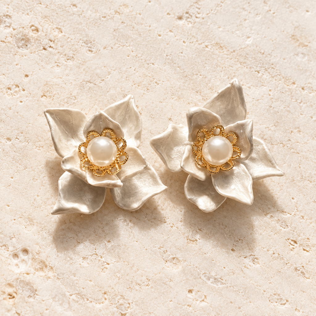 Handmade ivory porcelain clay magnolia stud earrings with freshwater pearl centers and gold-plated details
