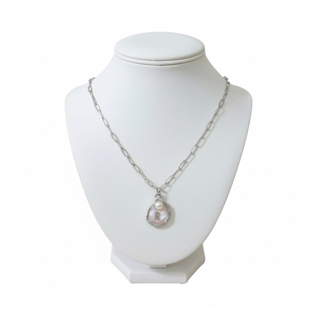 Custom oyster initial necklace with pearl on adjustable 16-inch stainless steel chain in silver.